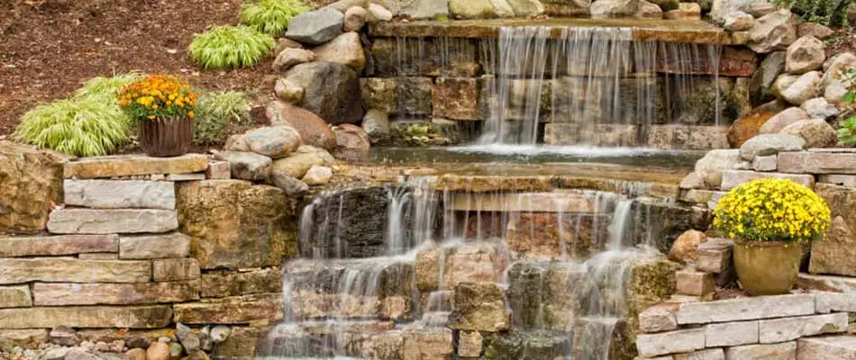 Custom waterfall landscaping feature installed at a Carlisle, IA home.