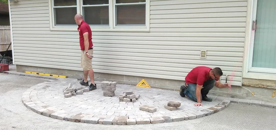 Our team building a new pave patio in the backyard of a home in Waukee, Iowa.