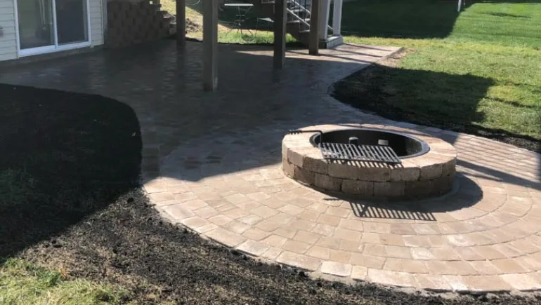 Custom fire pit and paver patio at a property in West Des Moines, Iowa.