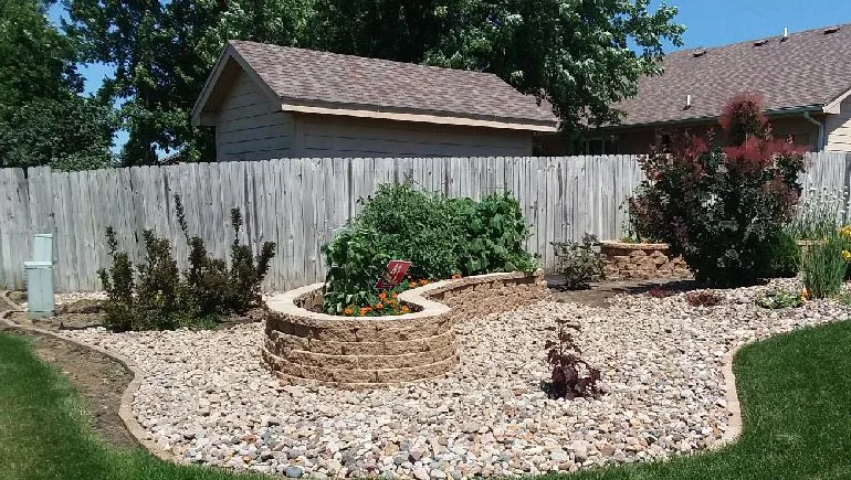 Retaining wall with planting bed and new landscaping at a home in Des Moines, Iowa