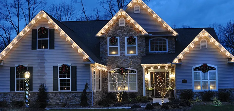 Homeowner in Des Moines with holiday lighting displays by A+ Lawn & Landscape.