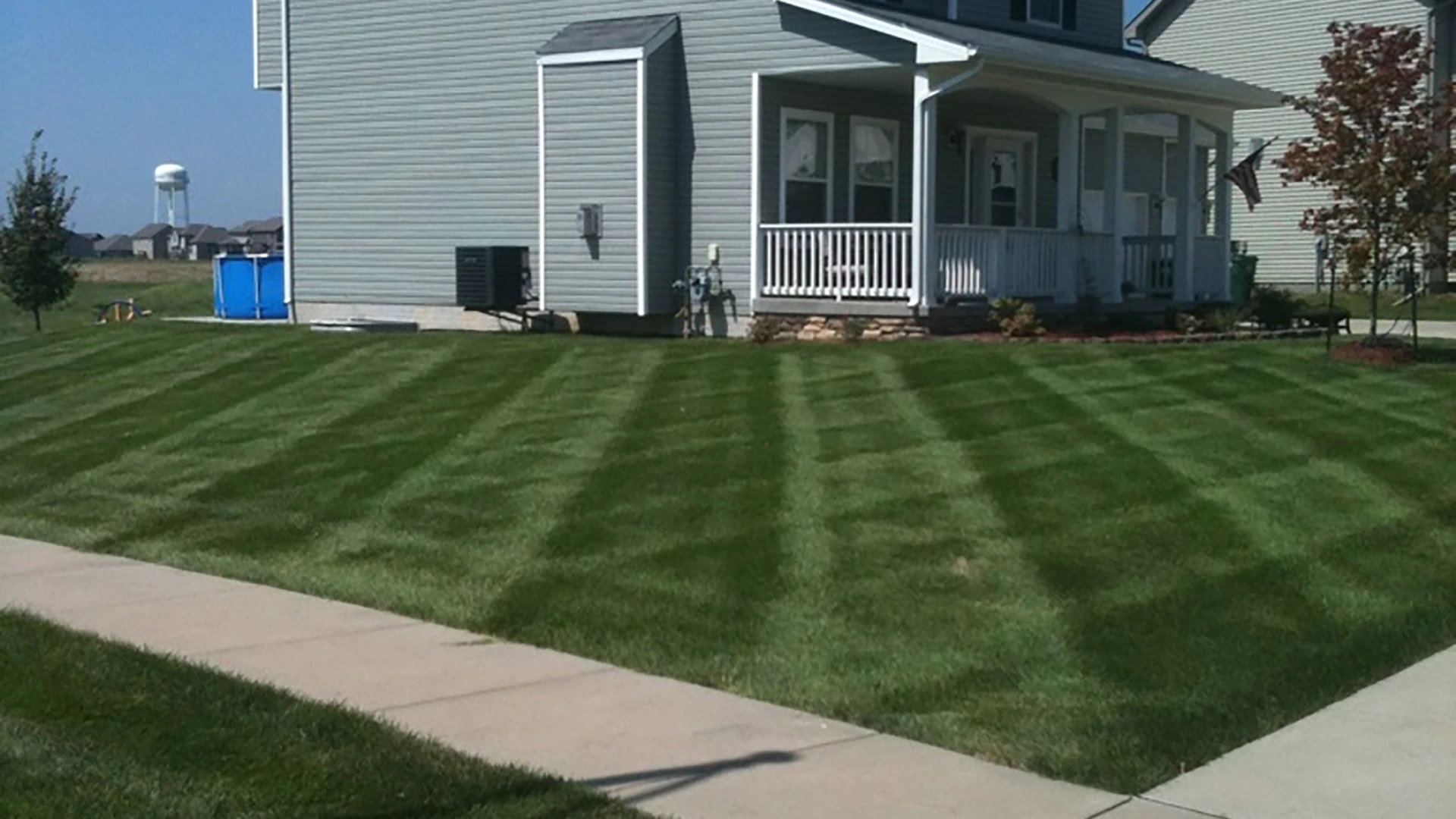 Homeowner in Des Moines, IA after weed control and fertilization services.