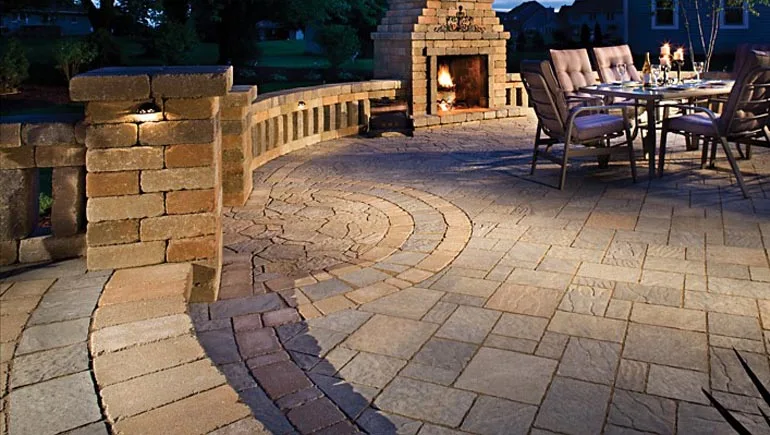 Stone patio, fireplace and seating wall constructed at a home in Ankeny, IA.