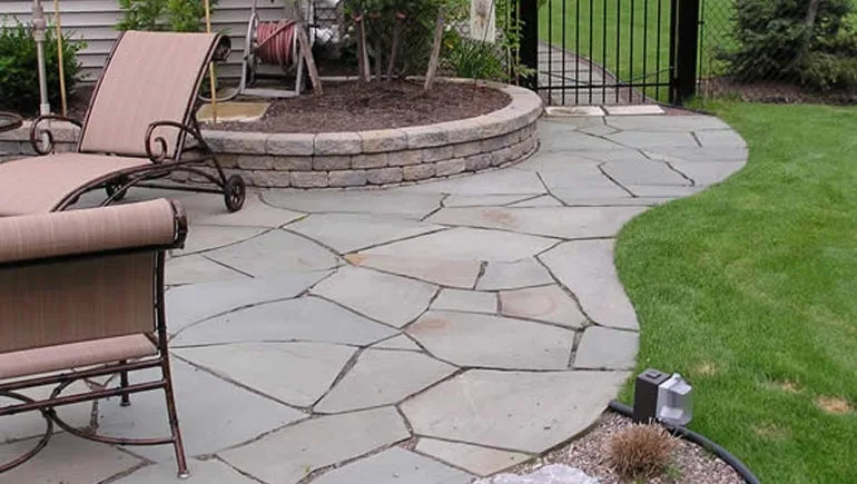 A new flagstone patio and pathway designed and installed by our team at a home in West Des Moines, IA