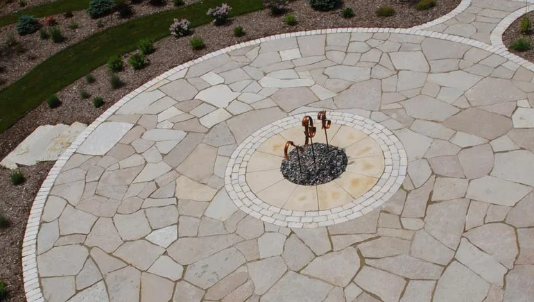 Flagstone patio with fire pit installed at a home in Norwalk, Iowa.