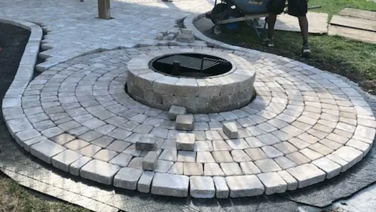 Paver patio and fire pit construction at a Des Moines, IA home.
