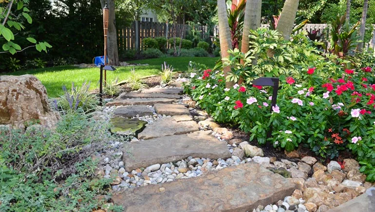 Beautiful stone pathway with a newly planted softscape at a home in Windsor Heights, Iowa.