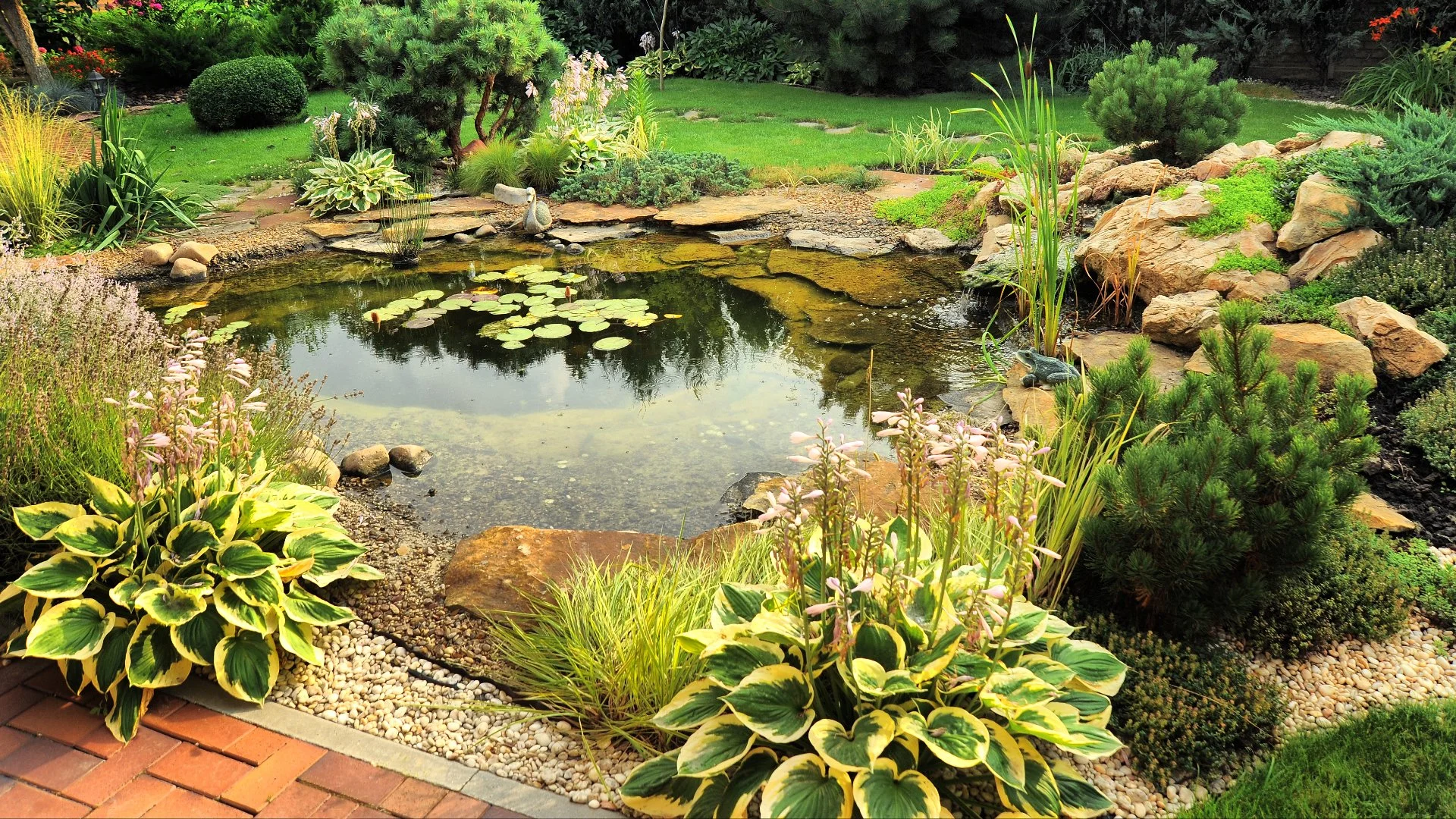 A beautiful rock waterfall professionally installed by our skilled employees at a home in West Des Moines, IA.