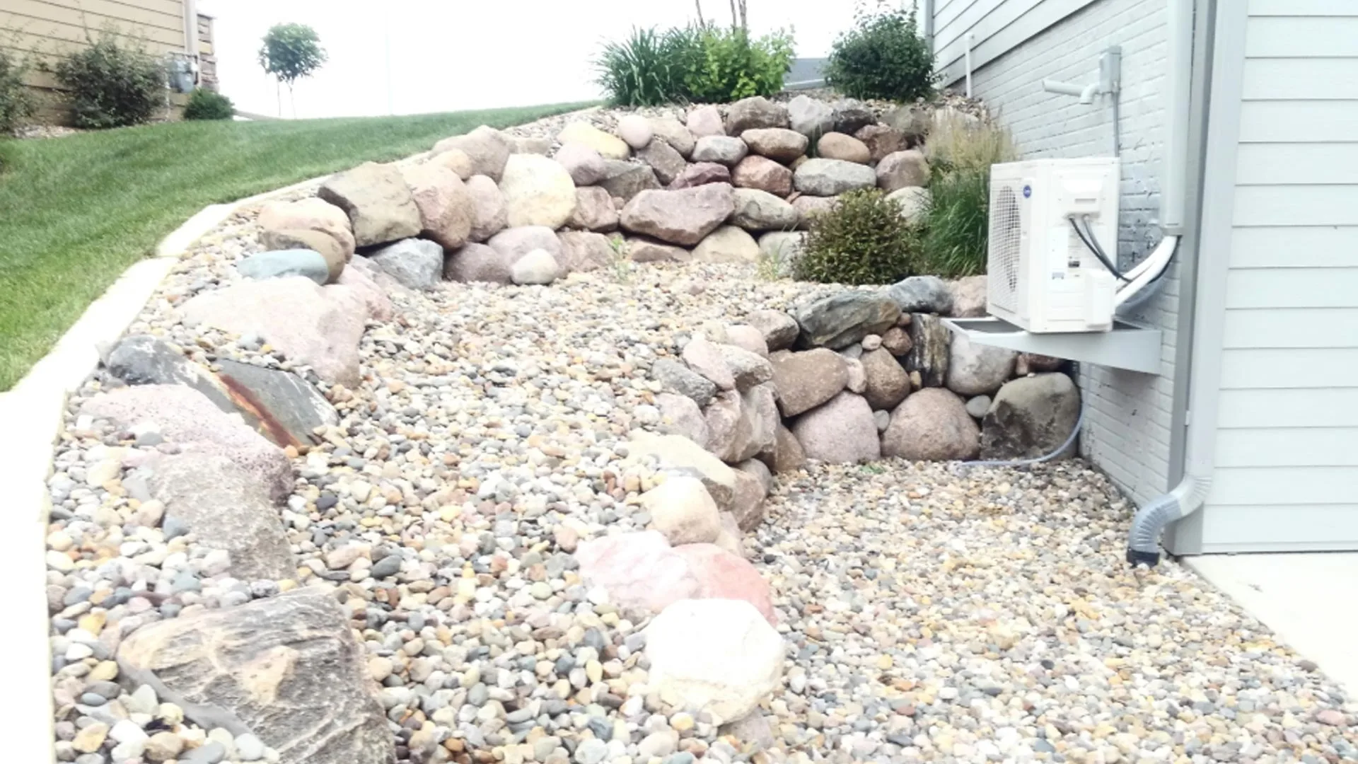 Rock landscape bed in property in Des Moines, IA.