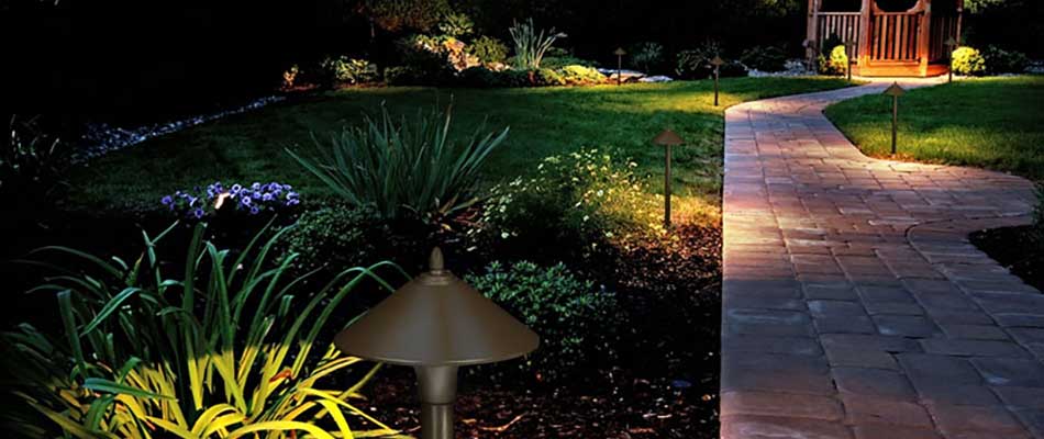 This custom stone pathway in Ankeny, IA is lit up with an outdoor lighting system.