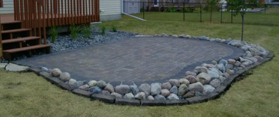 Decorative rocks around a paver patio in Des Moines, IA.