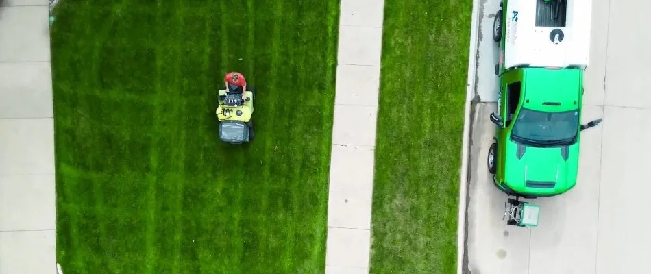 Fertilizer being spread by machine on a lawn in Des Moines, IA.