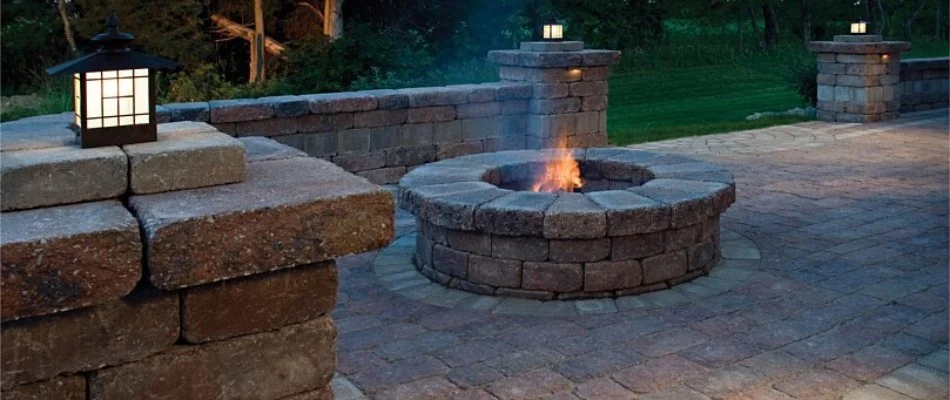 Fire pit and seating wall on a patio in Des Moines, IA.