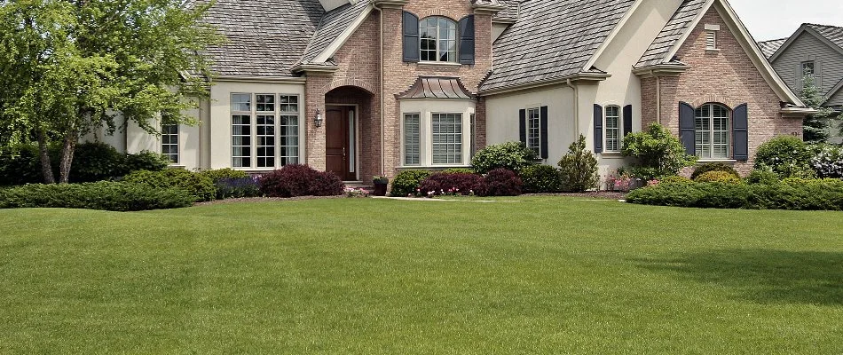 Large house in Des Moines, IA, with a front lawn and plants.