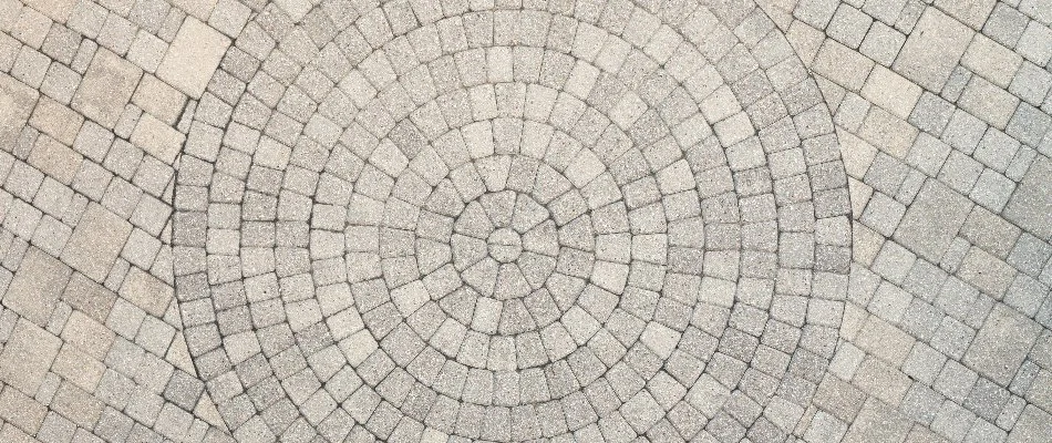 Patio in Des Moines, IA, with pavers arranged in a circular pattern.