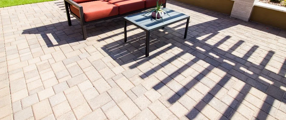 Paver patio in Des Moines, IA, with a red chair and table.