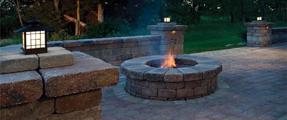 Paver patio in Des Moines, IA, with fire pit and seating wall.