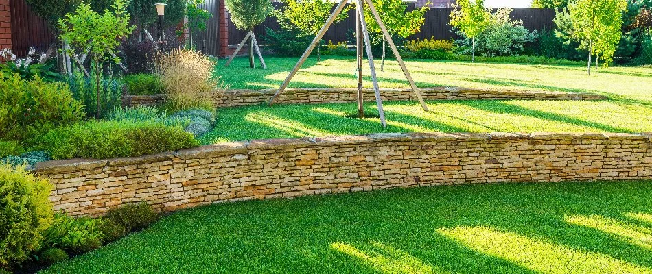 Retaining walls in Des Moines, IA, in between lawn areas.
