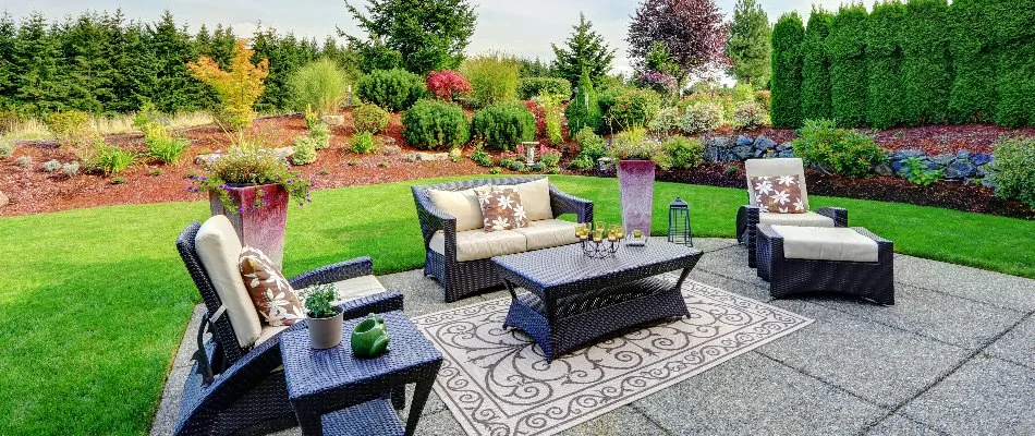 Trees, shrub, and flowers around a patio in Des Moines, IA.