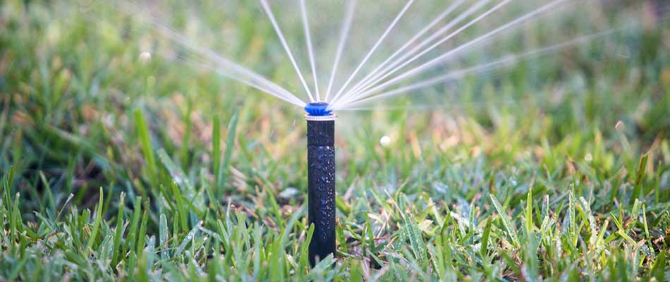 Watering an Altoona, IA property with irrigation sprinklers.