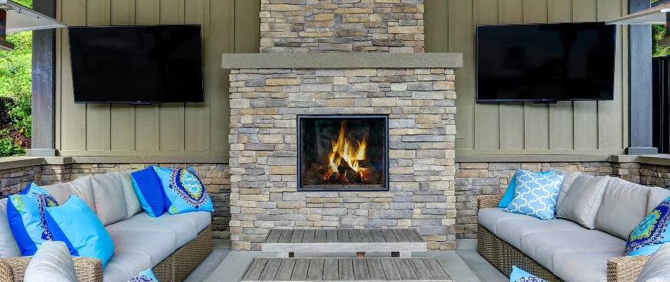 Wood-burning outdoor fireplace and sofas in Iowa.