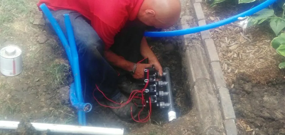 One of our expert lawn technicians installing a new irrigation system.