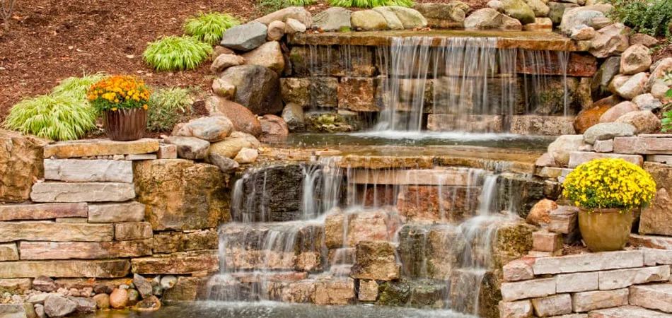 Rock waterfall and landscaping that was recently installed in the backyard of a home in West Des Moines, IA.