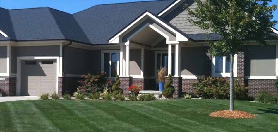 Property owners, like this one in West Des Moines, can eradicate the weeds in their lawn with the weed control services from A+ Lawn & Landscape.