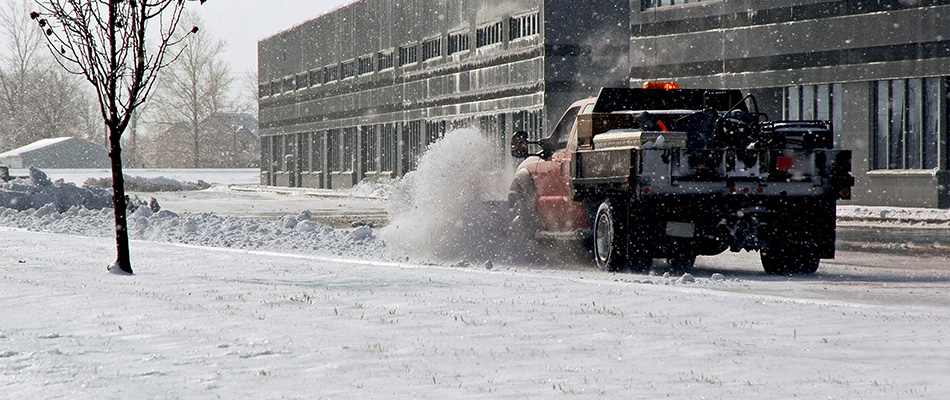 Professional crew removing snow from parking lot in Urbandale, IA.