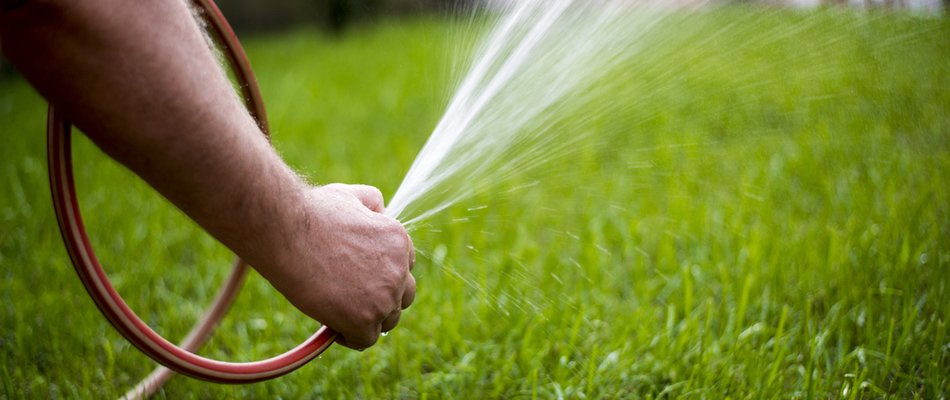 Our client in Dallas Center watering his own lawn in the beginning of spring. 