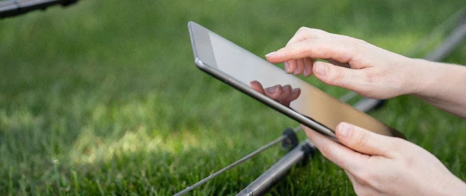 Irrigation system being controlled by tablet on a property in Des Moines, IA.