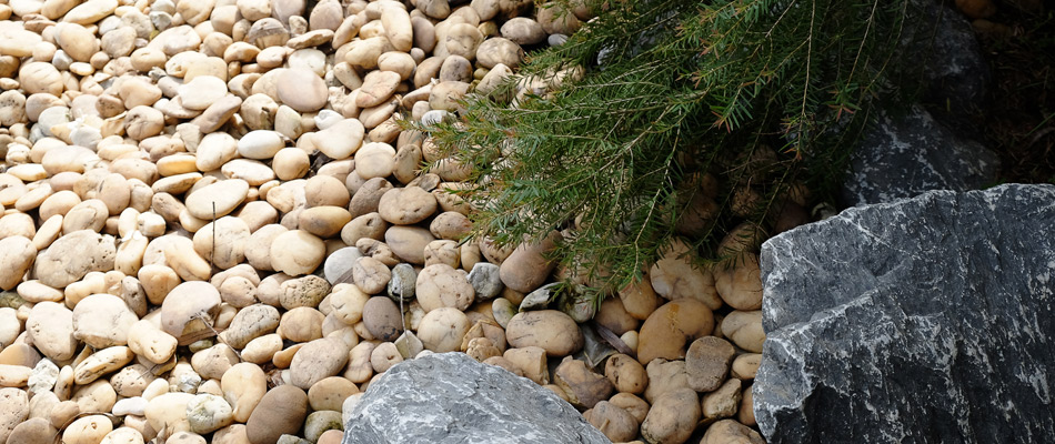 River rock installed in landscape in Clive, IA.