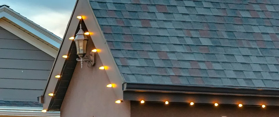 Roofline in Des Moines, IA, with white holiday lights.