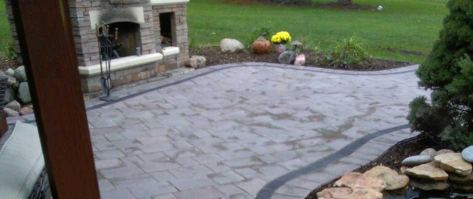 Patio installation with outdoor fireplace in Des Moines, IA.